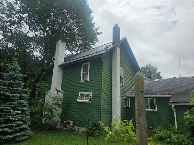 31 S Main St, Cohocton, NY 14826 - view of side of home with a chimney and a metal roof