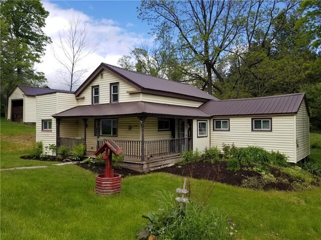 110 Furnace Hill Rd, Guilford, NY 13780 - view of front of house featuring a porch, a front lawn, and metal roof