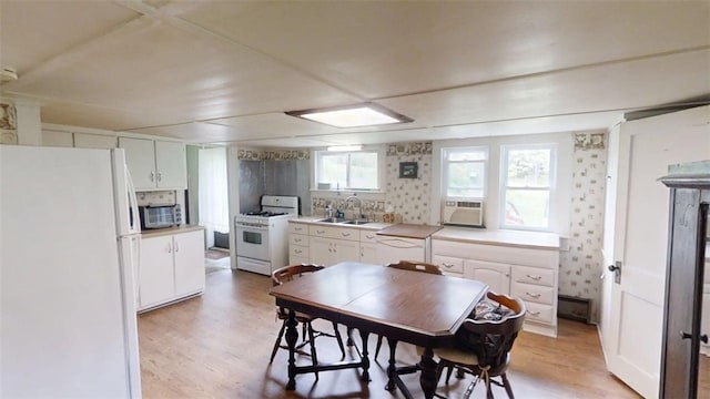 110 Furnace Hill Rd, Guilford, NY 13780 - kitchen with white appliances, light wood finished floors, white cabinetry, a sink, and light countertops