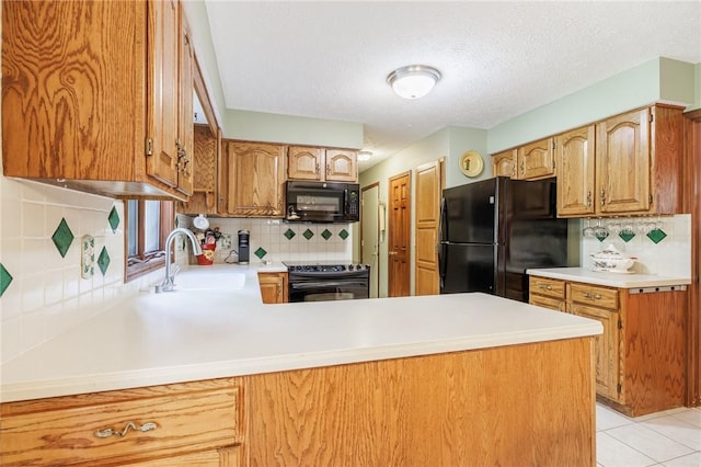 144 Guygrace Ln, Penfield, NY 14580 - kitchen with black appliances, a sink, tasteful backsplash, a peninsula, and a textured ceiling