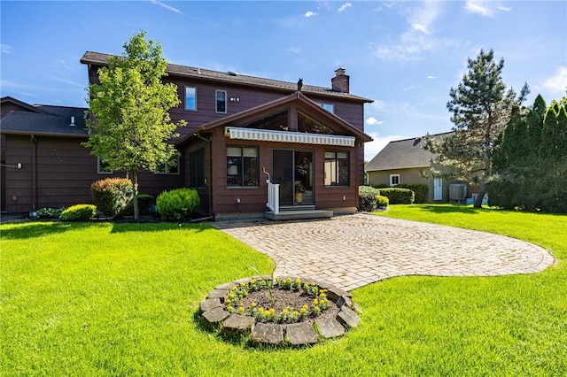 144 Guygrace Ln, Penfield, NY 14580 - back of house with a yard, a chimney, and central AC