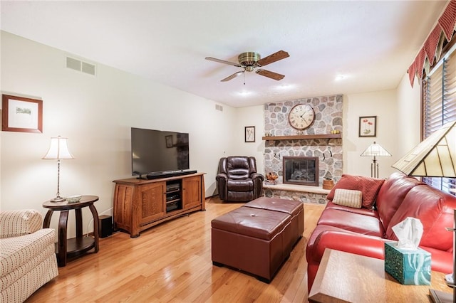144 Guygrace Ln, Penfield, NY 14580 - living room featuring ceiling fan, light wood finished floors, and a fireplace