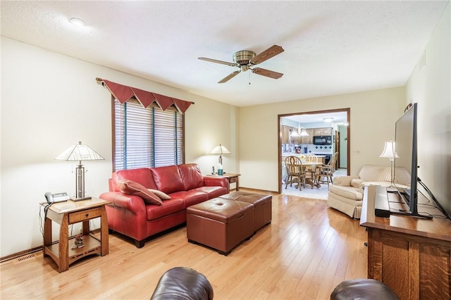 144 Guygrace Ln, Penfield, NY 14580 - living area featuring a ceiling fan and light wood-style floors