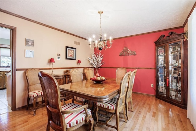 144 Guygrace Ln, Penfield, NY 14580 - dining area with a chandelier, light wood-style flooring, ornamental molding, and baseboards