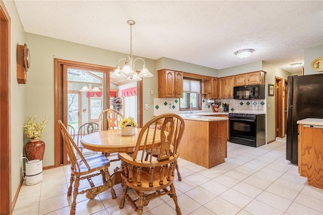144 Guygrace Ln, Penfield, NY 14580 - dining area with a chandelier, a textured ceiling, and light tile patterned floors