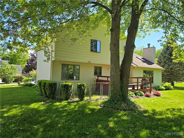 589 Briarwood Ln, Lewiston, NY 14092 - rear view of property featuring a lawn and a deck