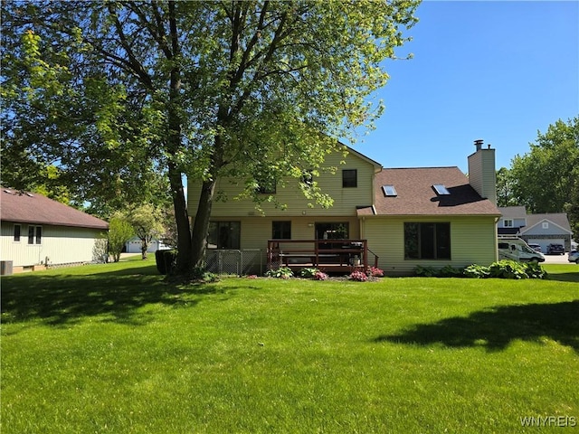 589 Briarwood Ln, Lewiston, NY 14092 - back of property featuring a chimney, a lawn, and a deck