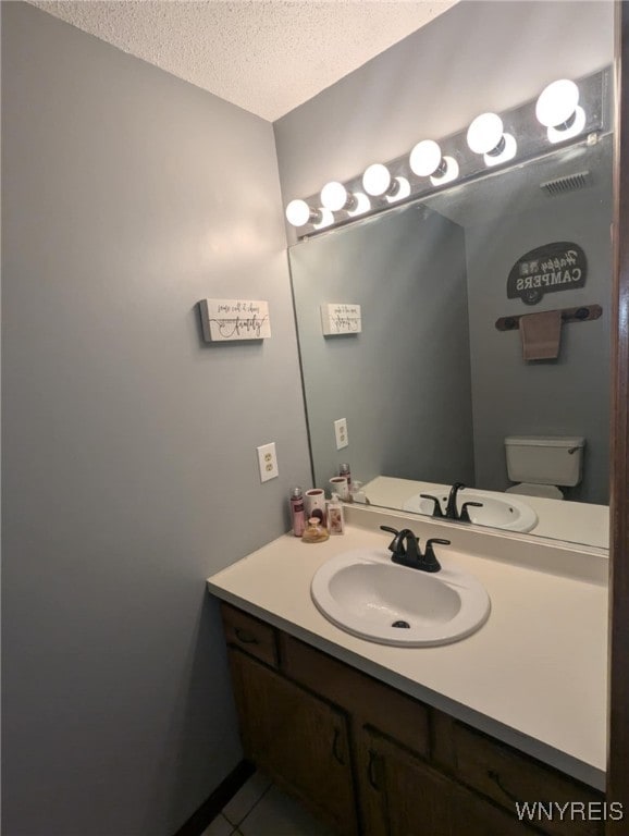589 Briarwood Ln, Lewiston, NY 14092 - bathroom featuring vanity, a textured ceiling, toilet, and tile patterned flooring
