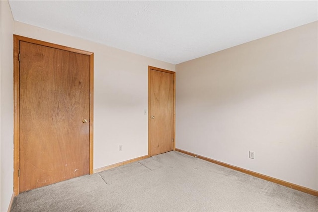 194 Citation Dr, Henrietta, NY 14467 - unfurnished bedroom featuring light carpet, baseboards, and a closet