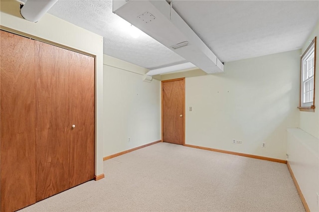 194 Citation Dr, Henrietta, NY 14467 - below grade area with light colored carpet and baseboards
