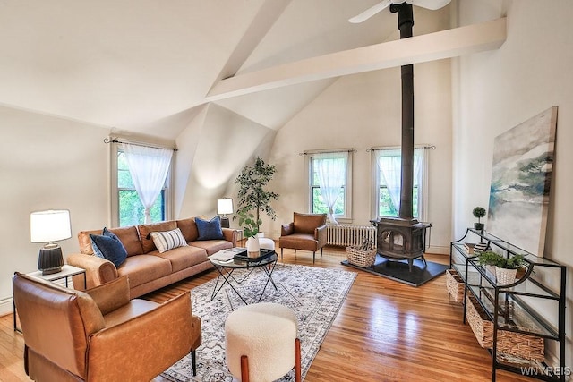 403 Elmwood Ave, Buffalo, NY 14222 - living area with a wood stove, healthy amount of natural light, light wood-style flooring, beam ceiling, and high vaulted ceiling