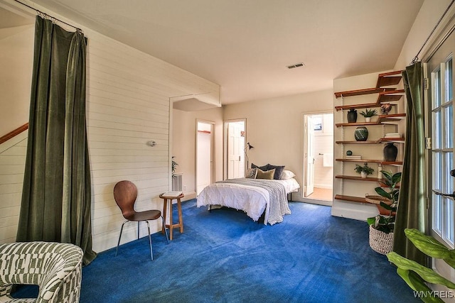 403 Elmwood Ave, Buffalo, NY 14222 - bedroom featuring carpet floors and wood walls