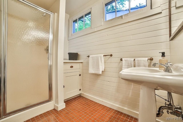 403 Elmwood Ave, Buffalo, NY 14222 - full bath with a stall shower, tile patterned flooring, wood walls, and baseboards
