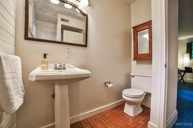 403 Elmwood Ave, Buffalo, NY 14222 - bathroom featuring toilet, baseboards, and tile patterned flooring