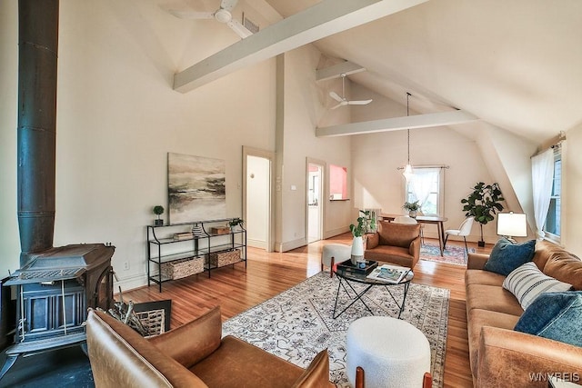 403 Elmwood Ave, Buffalo, NY 14222 - living room with ceiling fan, a wood stove, wood finished floors, high vaulted ceiling, and beam ceiling