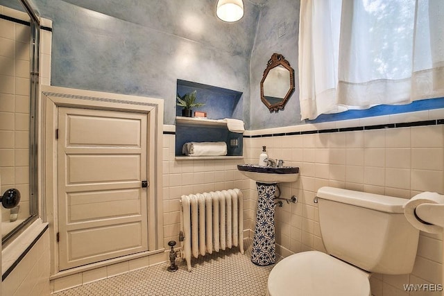 403 Elmwood Ave, Buffalo, NY 14222 - full bath featuring radiator heating unit, toilet, tile patterned flooring, tile walls, and tiled shower / bath combo