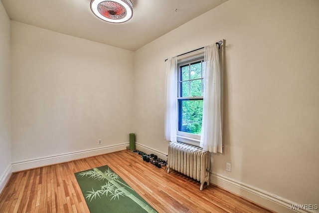 403 Elmwood Ave, Buffalo, NY 14222 - empty room featuring radiator, baseboards, and wood finished floors