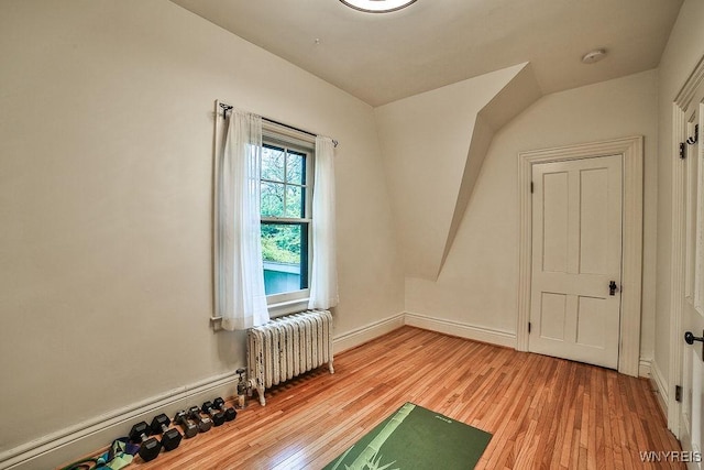 403 Elmwood Ave, Buffalo, NY 14222 - workout area featuring radiator heating unit, light wood-type flooring, and baseboards