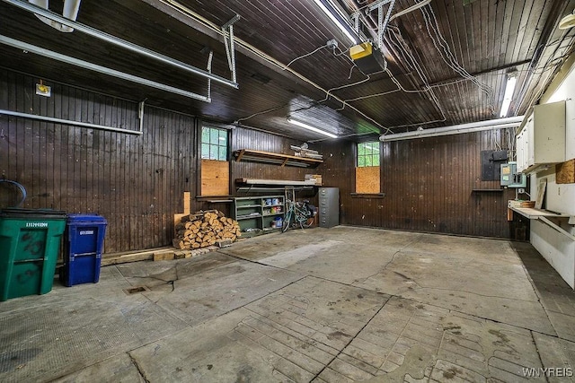 403 Elmwood Ave, Buffalo, NY 14222 - garage with wooden walls, a garage door opener, and electric panel