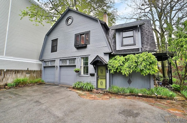 403 Elmwood Ave, Buffalo, NY 14222 - colonial inspired home with a gambrel roof, an attached garage, driveway, and a chimney