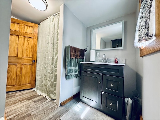 245 Owego St, Montour, NY 14865 - bathroom with wood finished floors, vanity, and baseboards