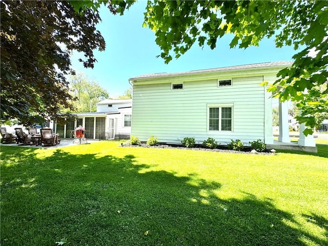 245 Owego St, Montour, NY 14865 - rear view of house with a yard, a patio area, and a sunroom