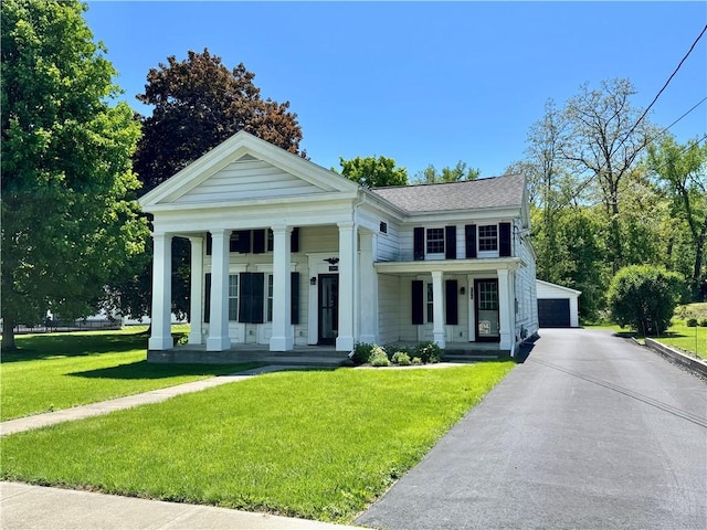 245 Owego St, Montour, NY 14865 - greek revival house featuring covered porch, a detached garage, and a front lawn