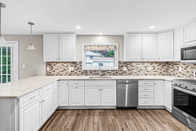 5 Glencrest Blvd, New Hartford, NY 13413 - kitchen featuring stainless steel appliances, a sink, white cabinets, a peninsula, and decorative backsplash