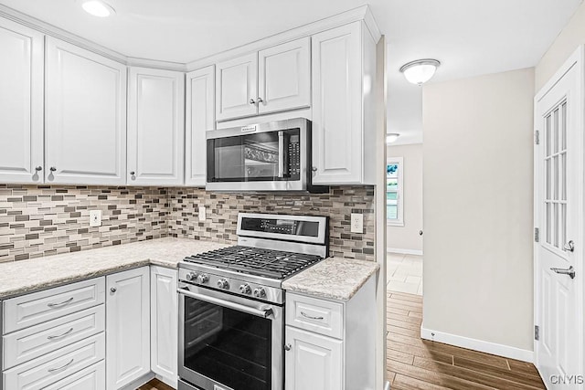 5 Glencrest Blvd, New Hartford, NY 13413 - kitchen with appliances with stainless steel finishes, backsplash, white cabinetry, baseboards, and dark wood-style flooring