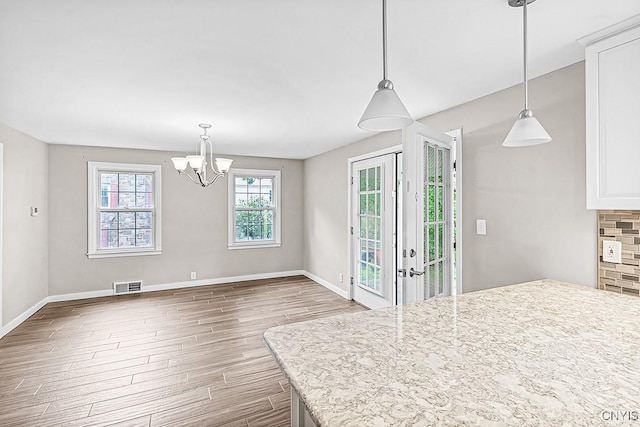 5 Glencrest Blvd, New Hartford, NY 13413 - kitchen featuring wood finished floors, a chandelier, baseboards, decorative backsplash, and hanging light fixtures