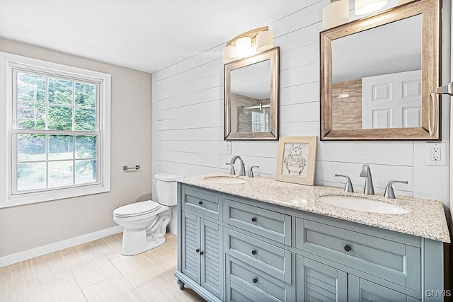 5 Glencrest Blvd, New Hartford, NY 13413 - full bathroom featuring wood walls, double vanity, baseboards, toilet, and a shower