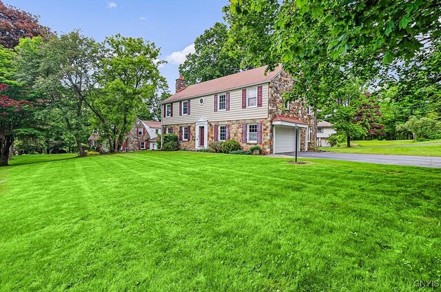 5 Glencrest Blvd, New Hartford, NY 13413 - colonial inspired home featuring stone siding, driveway, a chimney, a front lawn, and a garage
