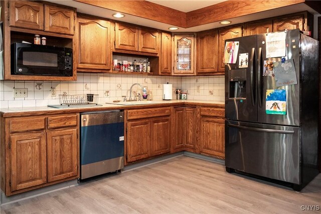 1466 Grant Rd, Russia, NY 13324 - kitchen with black appliances, brown cabinets, a sink, light wood finished floors, and recessed lighting