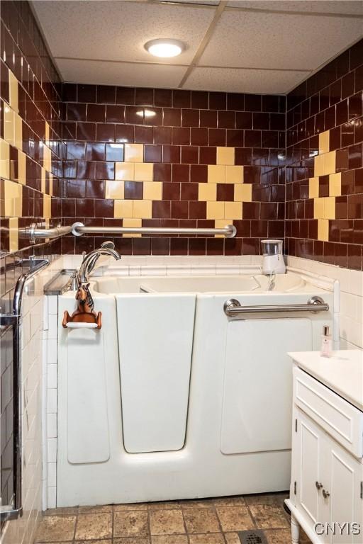 1466 Grant Rd, Russia, NY 13324 - bathroom with tile walls, a bath, and vanity