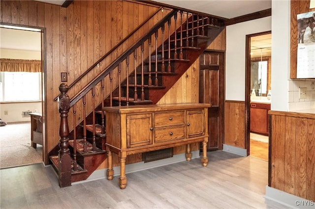 1466 Grant Rd, Russia, NY 13324 - stairway featuring wooden walls, wood finished floors, and wainscoting