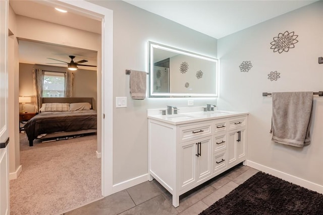 25 San Mateo Rd, Chili, NY 14624 - ensuite bathroom featuring double vanity, baseboards, a ceiling fan, and tile patterned floors