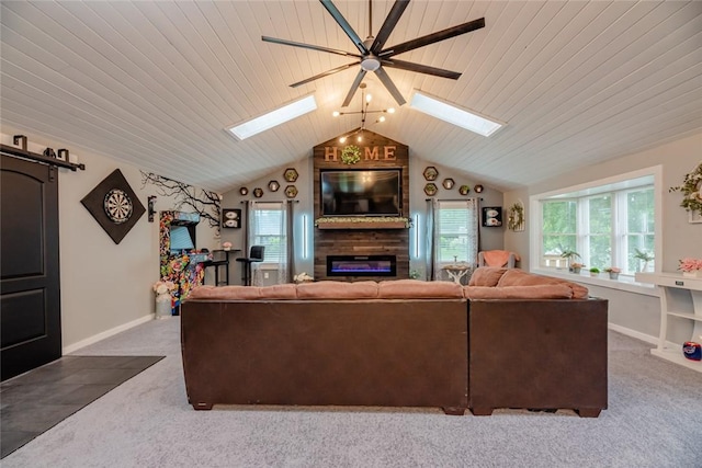 25 San Mateo Rd, Chili, NY 14624 - carpeted living room featuring a skylight, a glass covered fireplace, vaulted ceiling, a ceiling fan, and baseboards