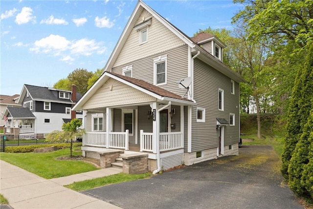 224 Lyell Ave, Ogden, NY 14559 - victorian home with covered porch, a front yard, and asphalt driveway