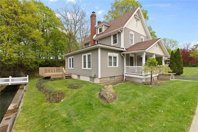 224 Lyell Ave, Ogden, NY 14559 - back of property with a porch, a chimney, and a lawn