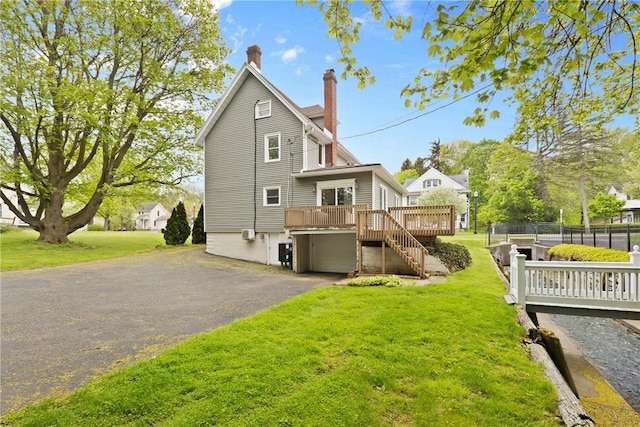 224 Lyell Ave, Ogden, NY 14559 - rear view of property featuring a deck, a chimney, driveway, and stairway