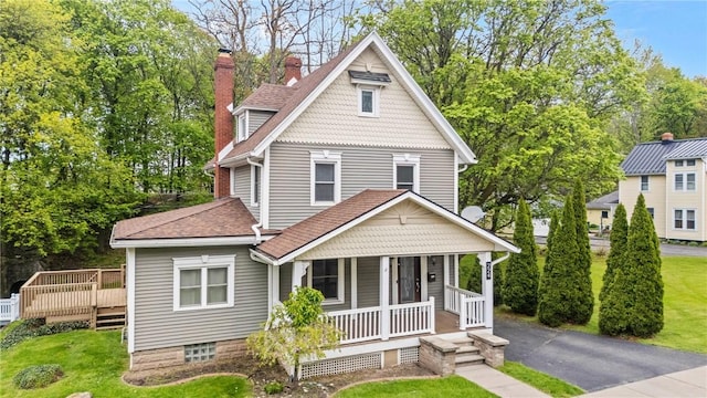 224 Lyell Ave, Ogden, NY 14559 - victorian house featuring covered porch, a front lawn, roof with shingles, and a chimney