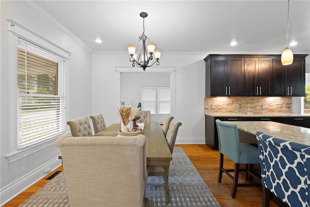 224 Lyell Ave, Ogden, NY 14559 - dining room featuring a chandelier, crown molding, wood finished floors, baseboards, and recessed lighting