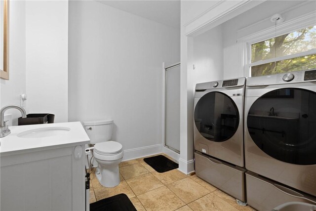 224 Lyell Ave, Ogden, NY 14559 - full bathroom with washing machine and dryer, a stall shower, toilet, vanity, and baseboards