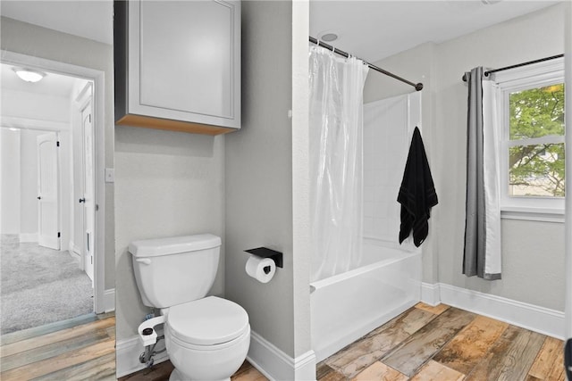 224 Lyell Ave, Ogden, NY 14559 - bathroom with shower / bath combo with shower curtain, toilet, wood finished floors, and baseboards