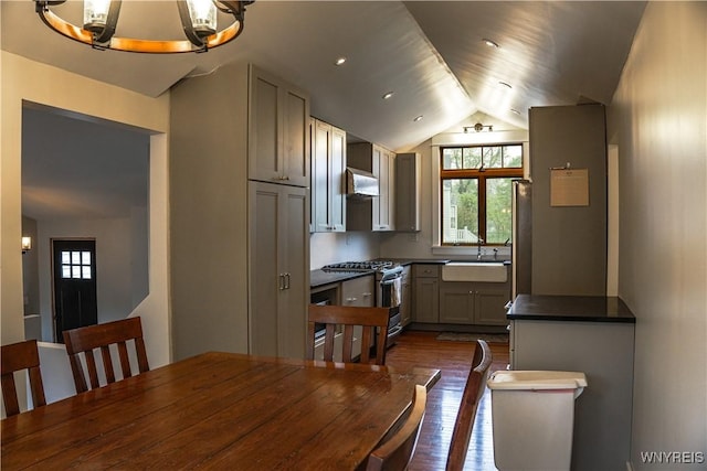 7401 Seneca St, Elma, NY 14052 - kitchen with stainless steel gas range, a sink, dark countertops, range hood, and dark wood-style flooring