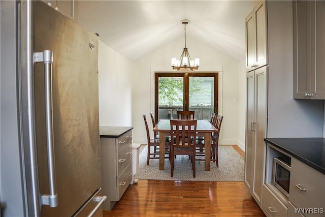 7401 Seneca St, Elma, NY 14052 - dining room with a chandelier, dark wood-style floors, and lofted ceiling