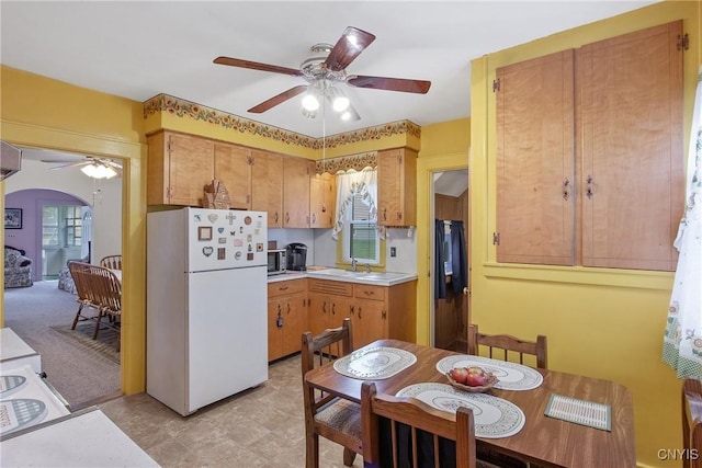 329 Hazelhurst Ave, Syracuse, NY 13206 - kitchen with freestanding refrigerator, ceiling fan, light countertops, and a sink