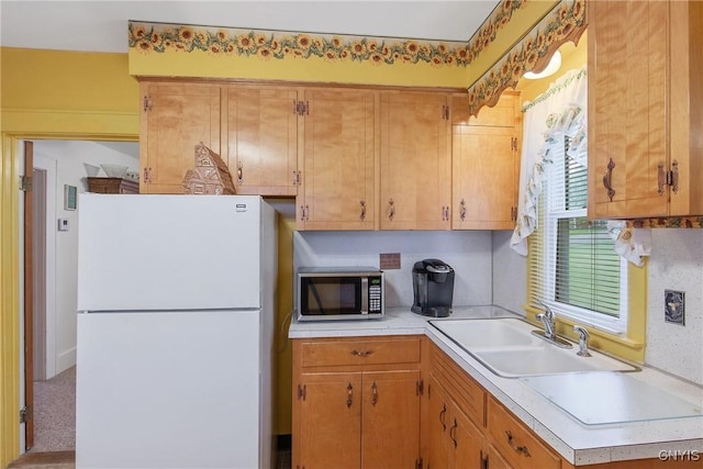 329 Hazelhurst Ave, Syracuse, NY 13206 - kitchen with freestanding refrigerator, stainless steel microwave, a sink, and light countertops