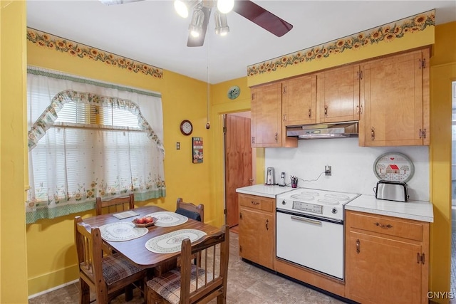 329 Hazelhurst Ave, Syracuse, NY 13206 - kitchen with white electric stove, under cabinet range hood, a ceiling fan, and light countertops