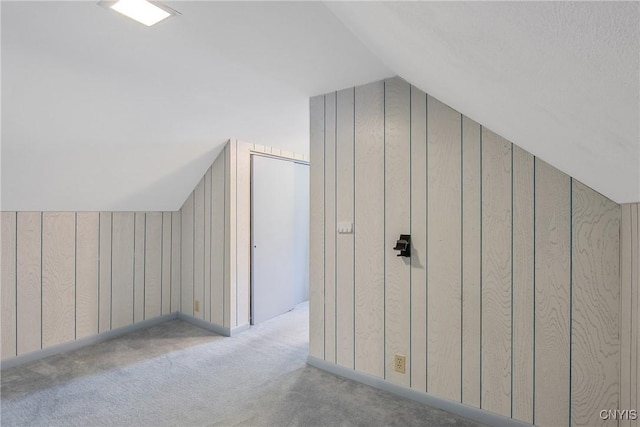 329 Hazelhurst Ave, Syracuse, NY 13206 - additional living space with vaulted ceiling, wooden walls, and carpet flooring